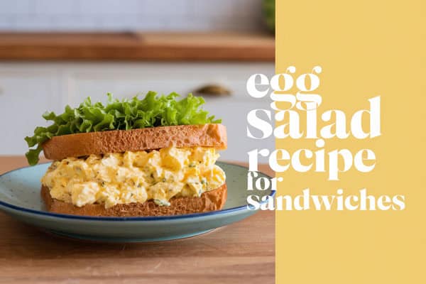 Classic egg salad sandwich with lettuce on whole grain bread, perfect for lunch.