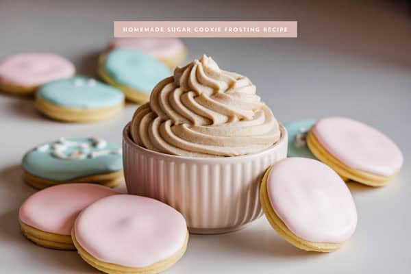 Delicious homemade sugar cookie frosting with pastel cookies for decorating.