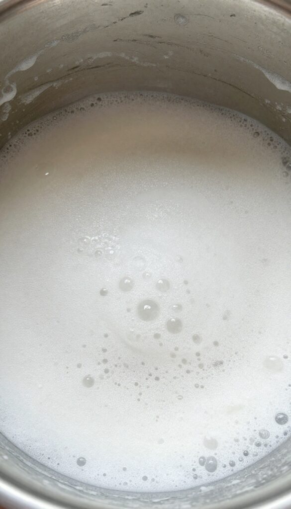 Baking soda paste fizzing with vinegar in an oven