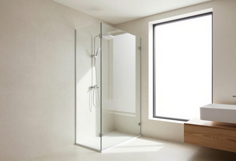 Modern shower with large beige tiles and glass enclosure