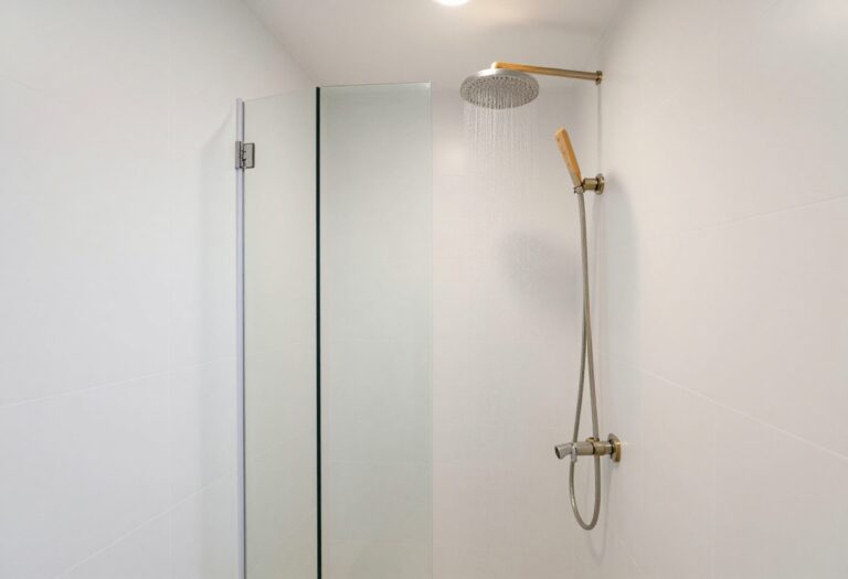 Modern half wall shower with glass panel in a bright bathroom