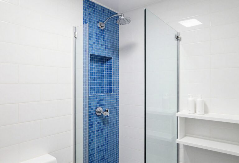 Modern shower with a vertical blue mosaic accent tile strip and matching niche against white subway tile.